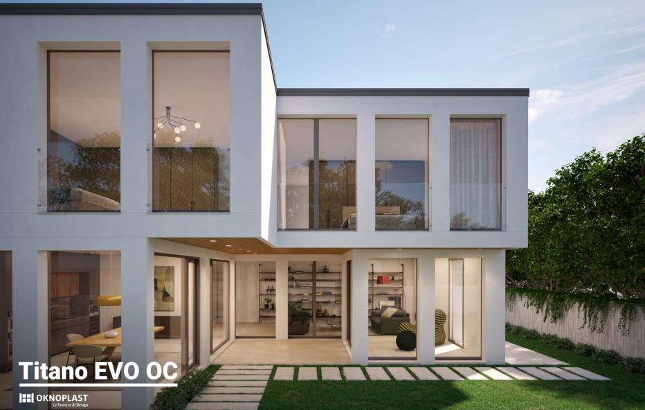 Moderna villa a due piani con ampie vetrate e giardino.